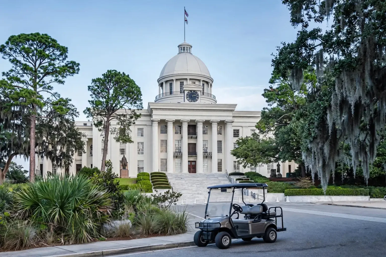 Golf cart parked on a street in front of a white domed government building, representing the Tater Harris golf cart case