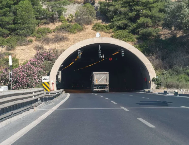 Vehicles including a truck approaching a highway tunnel entrance