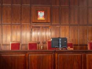 A judge's gavel resting on a desk in a courtroom