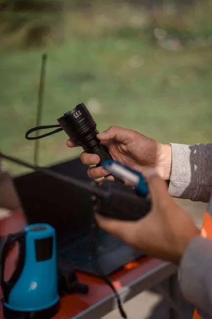 Person holding a flashlight and handheld radio equipment during an outdoor search