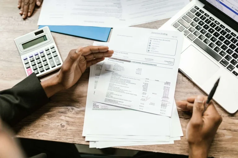 A checkbook and financial records on a desk