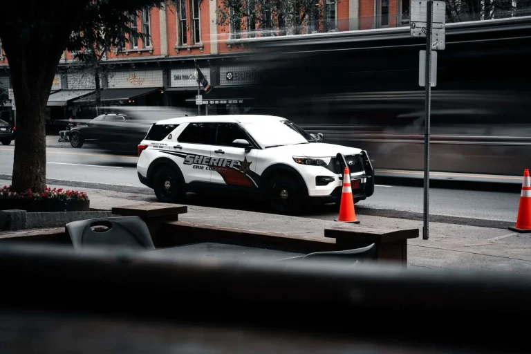 A county sheriff's patrol car parked outside a public building