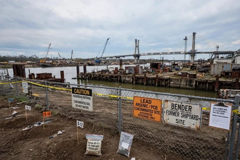 Industrial waterfront land along the Mobile River with cranes and downtown Mobile in the distance