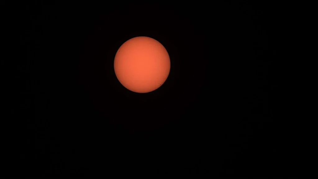 Bright sun in a hazy sky over the Gulf Coast during a hot September