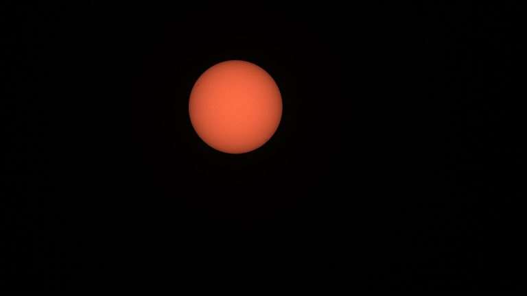 Bright sun in a hazy sky over the Gulf Coast during a hot September
