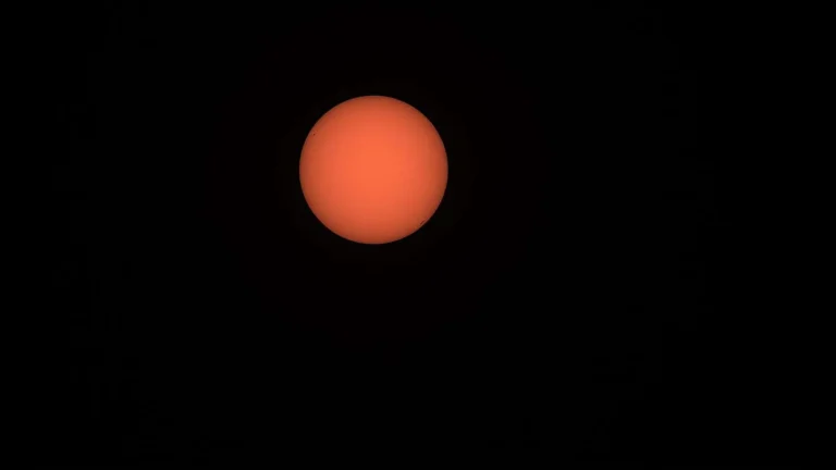 Bright sun in a hazy sky over the Gulf Coast during a hot September