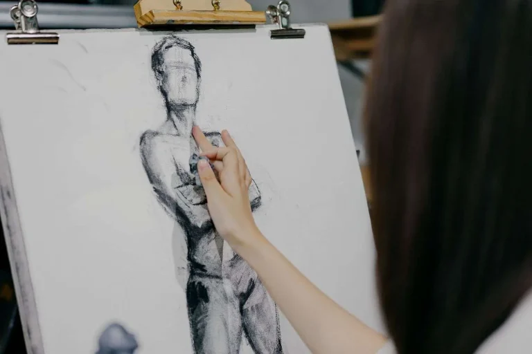 Artist sketching a human figure study in a studio