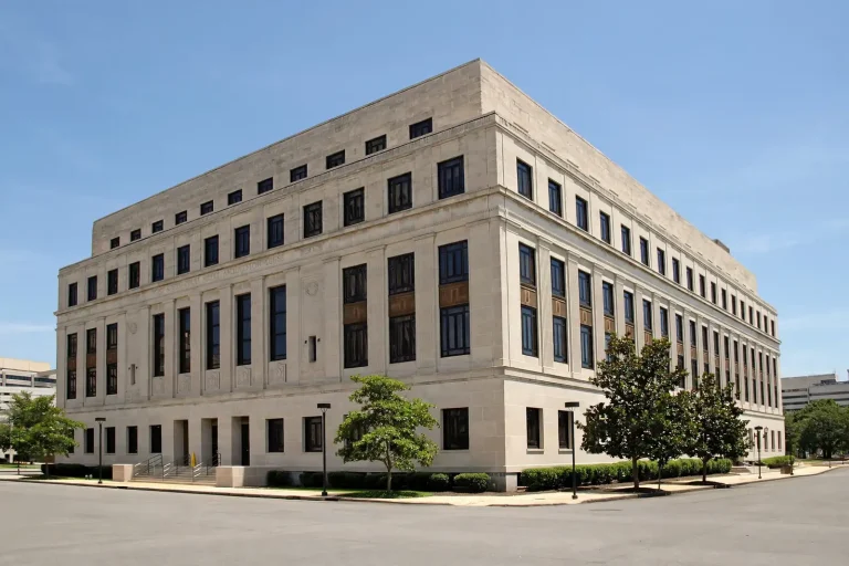 Large stone courthouse building on a clear day