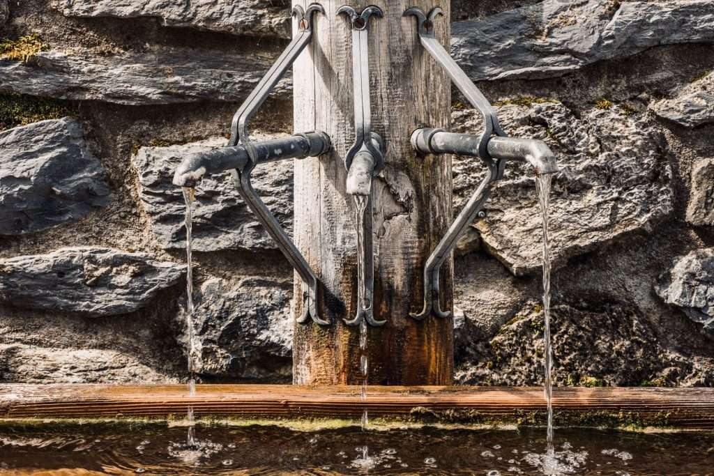 Running kitchen faucet representing water service and rates in Saraland