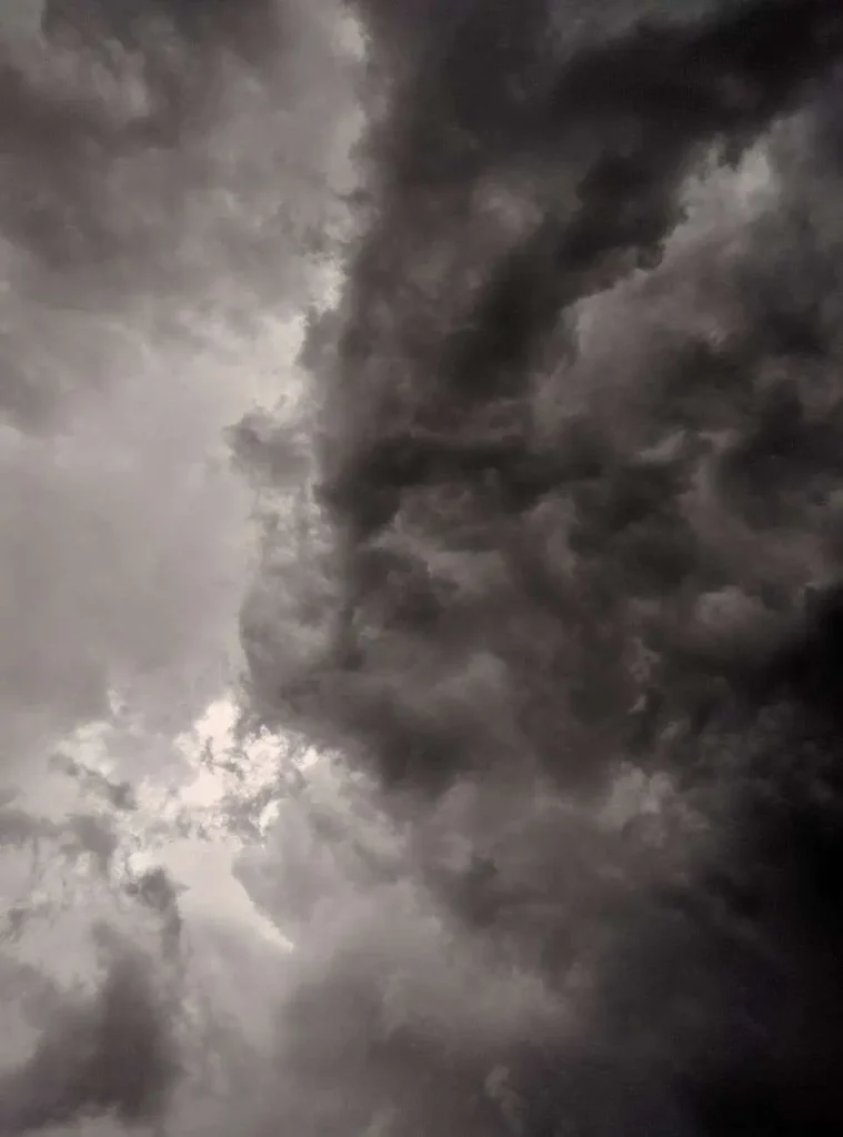 Dark, intense storm clouds filling the sky ahead of severe weather