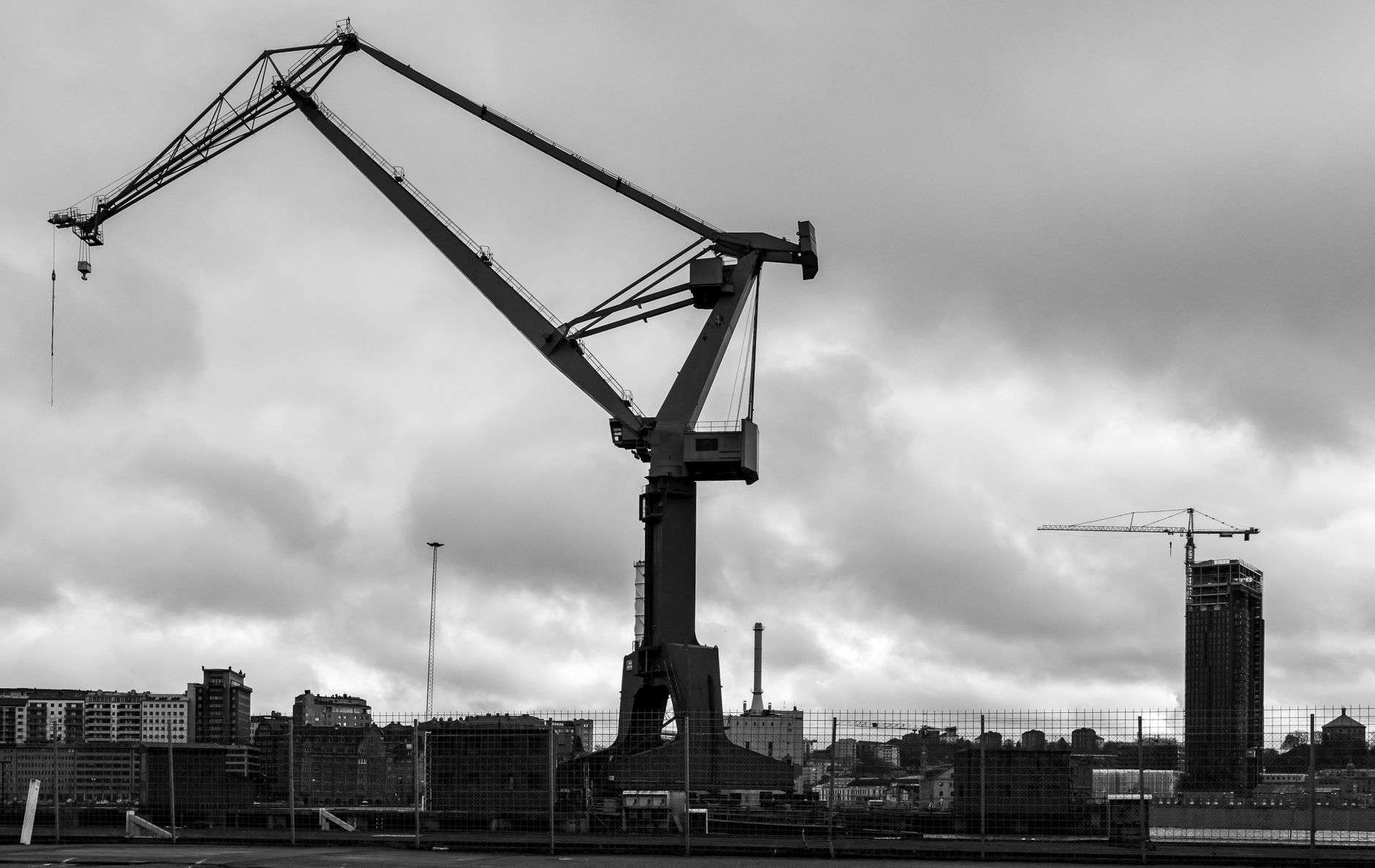 Large cranes rising over a shipyard on the water