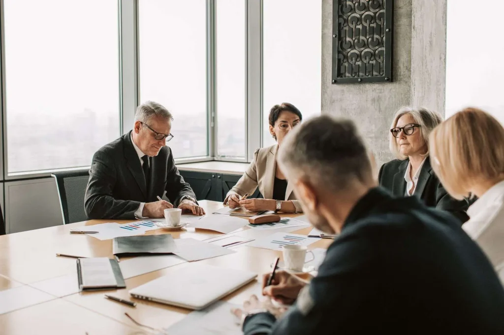 A professional boardroom with a conference table and chairs