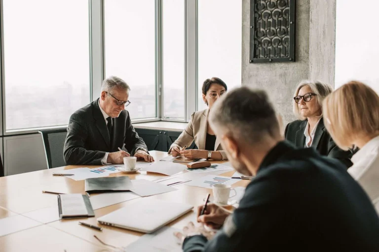 A professional boardroom with a conference table and chairs