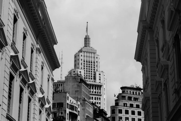A mid-century office building rising above a downtown business district
