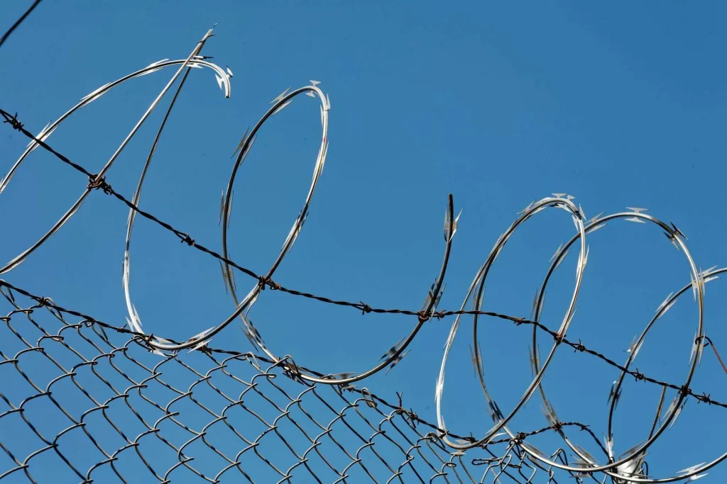 Razor wire atop a chain-link fence at a correctional facility