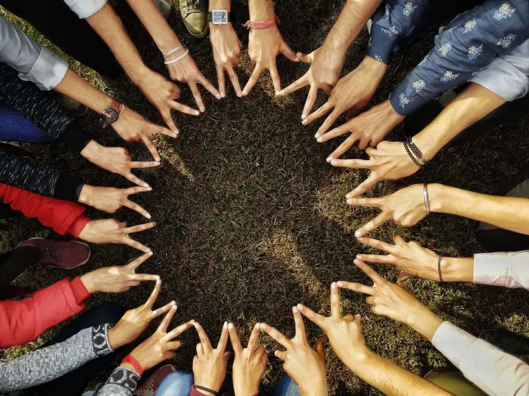 Small group of adults seated in a circle listening to one another during a supportive conversation