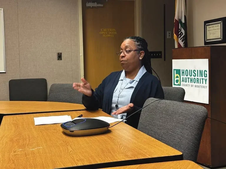 Zulieka Boykin speaking at a conference table in a Housing Authority of the County of Monterey meeting room